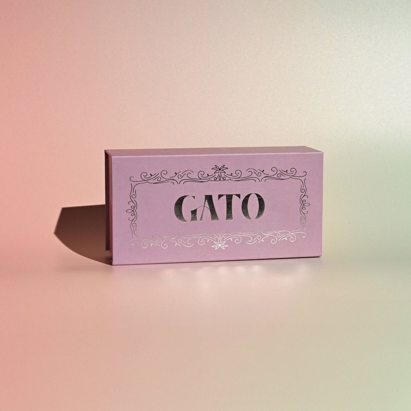Pink box with 'GATO' branding on a gradient background